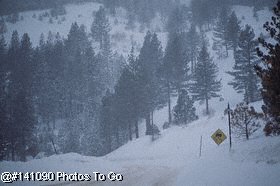 Empty snowy mountain road